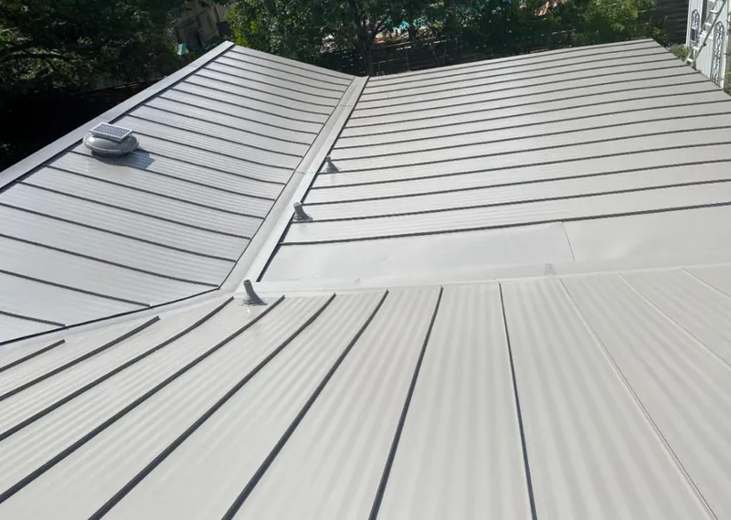 Solar attic fan installed on a metal roof for Roof Ventilation in Laguna Hills